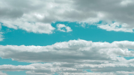Panoramic photo of surreal cloudscape on vivid blue sky. Panorama of lined dreamy clouds.
