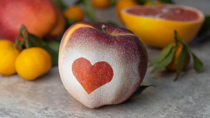 Red apple with a heart symbol. concept of love and health. healthy lifestyle and proper nutrition.