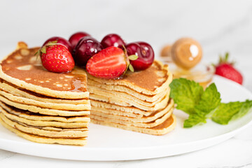 Pancake breakfast. Homemade pancakes with fresh berry and honey
