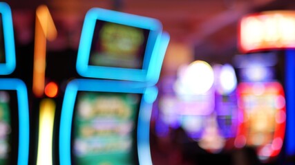 Defocused slot machines glow in casino on fabulous Las Vegas Strip, USA. Blurred gambling jackpot...