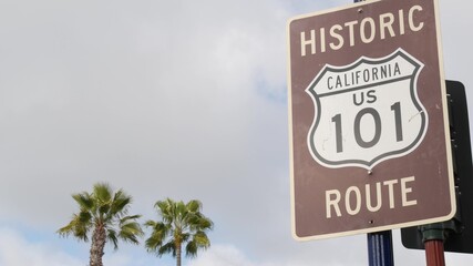 Pacific Coast Highway, historic route 101 road sign, tourist destination in California USA. Lettering on intersection signpost. Symbol of summertime travel along the ocean. All-American scenic hwy