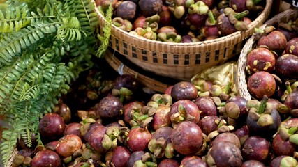 Fruits and vegetables on rustic stall. Assorted fresh ripe fruits and vegetables placed on rustic oriental stall in market. sweet tropical purple mangosteen. Queen of fruits in Thailand