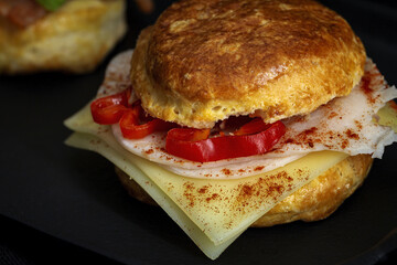 Assortment of homemade scones with ham, cheese, avocado, salmon, cream cheese and strawberry jam