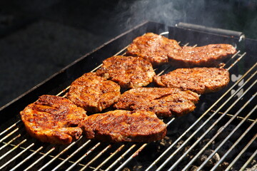 Pieces of neck on the grill, freshly grilled crispy meat, golden-brown color