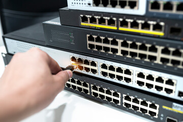 Network cable panels, switches and internet cables in data centers. The concept of cable infrastructure connected to data centers
