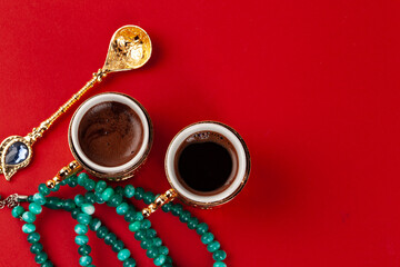 Turkish coffee in a golden oriental cup on red background