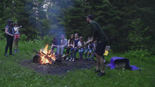 Scoutmaster making campfire.