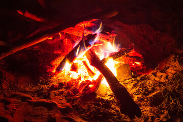 hot night bonfire on the sand close-up