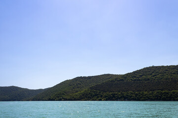 azure, lake, against backdrop mountains covered forest