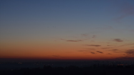 Beautiful sunset sky over the night  city.