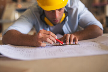 Carpenter underlining part of blueprint