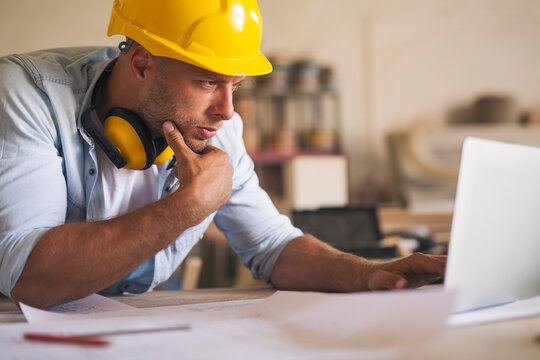 Woodworker using laptop for better understanding project blueprints - Powered by Adobe