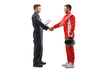 Full length profile shot of an auto mechanic shaking hands with a racer