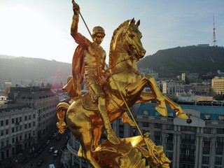Beautiful aerial drone photography. Country Georgia from above. Capital Tbilisi. Liberty square and close up portrait of  saint George golden monument.