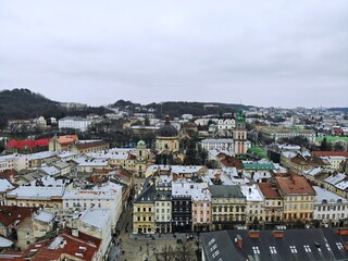 Aerial view from above of Lviv city, Ukraine. Beautiful drone photography. Main square and rooftop of city hall tower