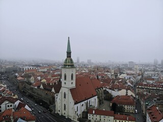 Naklejka na ściany i meble Slovakia, Bratislava. Historical old city centre. Aerial view from above, created by drone. Foggy day town landscape, travel photography.