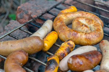 assorted meat sausages on the barbecue gril