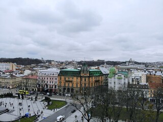 Aerial view from above of Lviv city, Ukraine. Beautiful drone photography. Ancient sculpture on rooftop of house