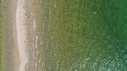 Fototapeta na wymiar Aerial view of calm clear sea water. Top view of a clean ocean water near a coast.