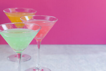 Several glasses of various delicious fruit non-alcoholic cocktails on a bright background. Health drinks