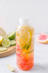Fototapeta na wymiar Citrus isotonic sports drink in bottle on white background