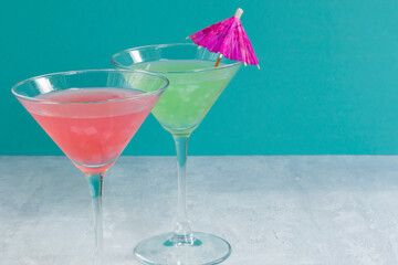 Glasses of assorted fruit non-alcoholic cocktails on a bright background with an umbrella. Health drinks.