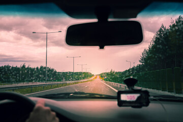 Driving on the Autobahn at sunset in rainy weather