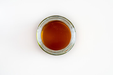 Open honey glass jar isolated on white background 