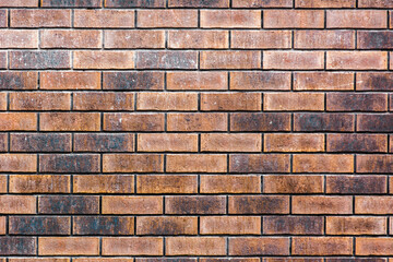 Texture of a brick or stone wall with scratches and relief. Orange, red and magenta colors. Geometric mosaic. Rectangles. Squares. Accuracy. Beautiful background with place for text.