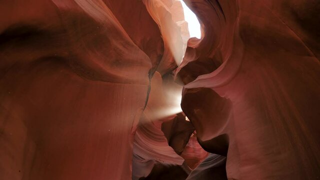 Antelope Canyon With Wavy And Smooth Stone Walls Of Red Color And Sun Ray Shines