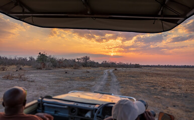 Enjoy the sunset over the car during game drive