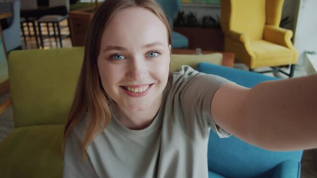 Happy young woman making facetime video chat calling with smartphone at home, using zoom conference meeting online app, social distancing, work from home, work remotely concept