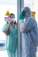 COVID-19, Corona Virus outbreak quarantine epidemic spread and social distancing concept. Asian doctors wear PPE  monitor patient health and encourage depressed CORONA or COVID-19 patient infection