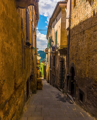 Fototapeta na wymiar A rustic side street in the settlement of Bagnoregio in Lazio, Italy in summer