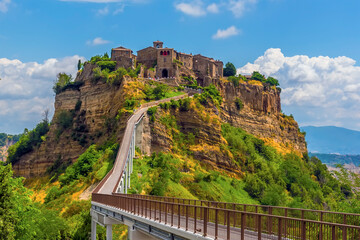 A close-up view approaching the hilltop settlement of Civita di Bagnoregio in Lazio, Italy in summer