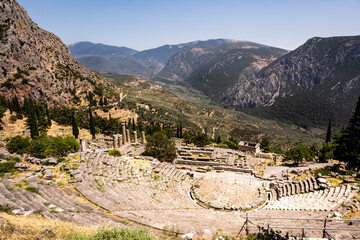Fototapeta na wymiar The historic theatre of the ancient city of Delphi in Greece overlooking the surrounding hills in summer.