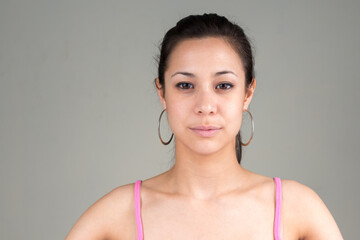 Portrait of young beautiful woman against white background