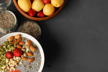 Chia pudding with strawberry and pumpkin seeds on wooden table