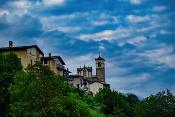 Fototapeta na wymiar Church bell tower and houses of the village of Caspano in Valtellina Sondrio Lombardy Italy