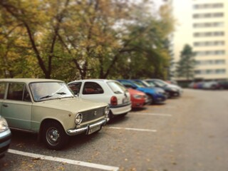 Old car in a parking lot in a modern city