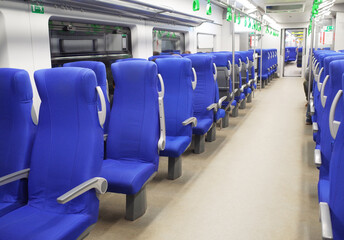 Blue seats in a high-speed train car.
