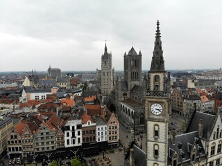 Fototapeta na wymiar Amazing view from above. Small and comfortable town Gent. Medieval history around you.Must see for all explorer. View from Drone. From Belgium with Love. Clock tower.