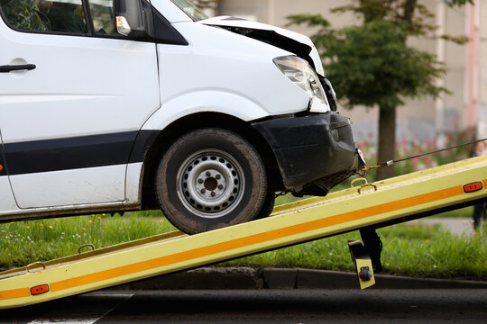 Crashed car is immersed in tow truck closeup. Car evacuation after an accident concept