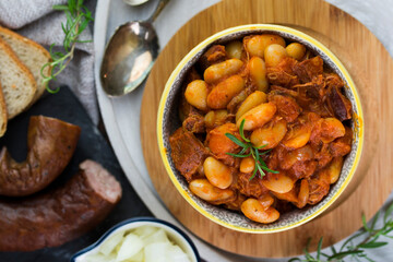 Stewed beans in tomato sauce with herbs and spices.  Top view.