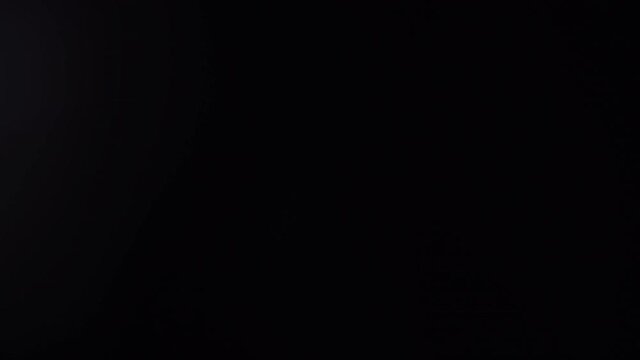 glass prism rotating in front of camera lens creating cool light flares and leaks, nice video transition or overlay in 4k at 25fps.
