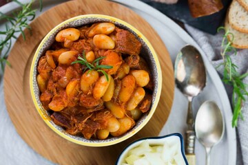 Stewed beans in tomato sauce with herbs and spices.  Top view.