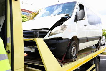 Wrecked car stands on tow truck closeup. Car evacuation services concept