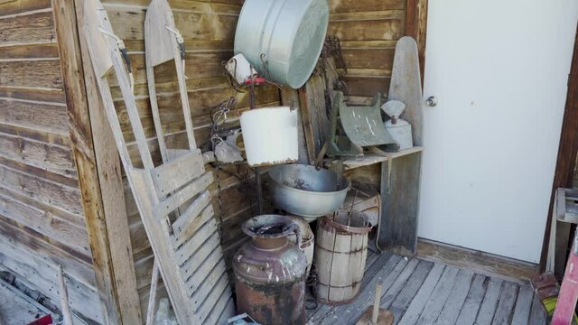 Antique items on the back porch of an old abandoned cabin in the old west