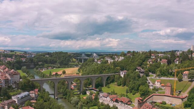 Aerial of charming Fribourg with Zahringen Bridge crossing Saane river in green valley