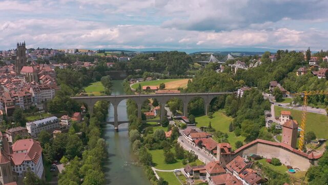 Historical Zaehringen Bridge crosses over Saane river in the cultural city of Freiburg, aerial